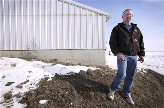 Doug Boyer of Oakville, Iowa,&nbsp;stands near a hog confinement building on his farm that shows a high water mark from the flood of 2008. He's among those critical of FEMA's new flood maps..